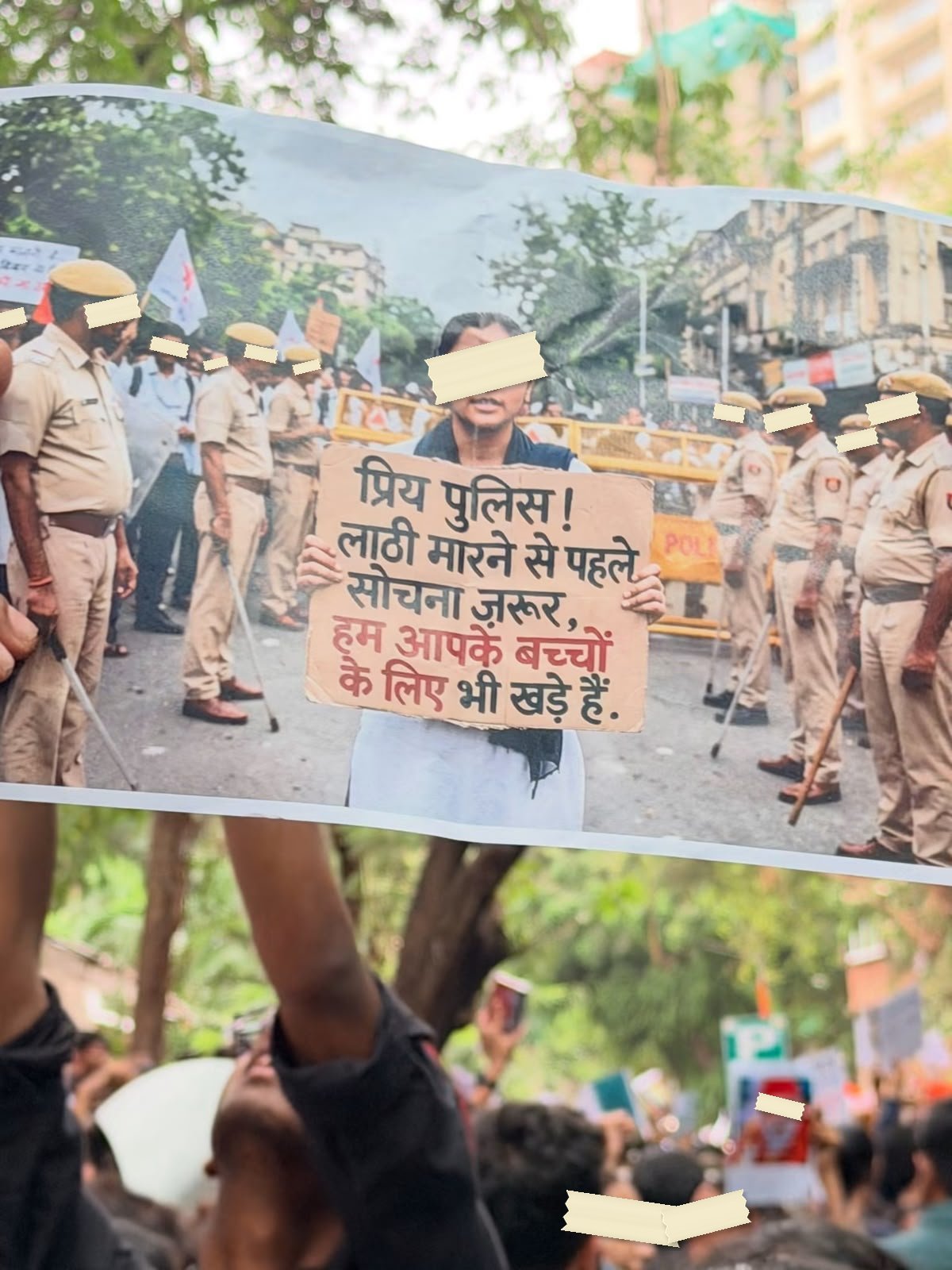 Archive photograph of a hand-made poster in a crowd