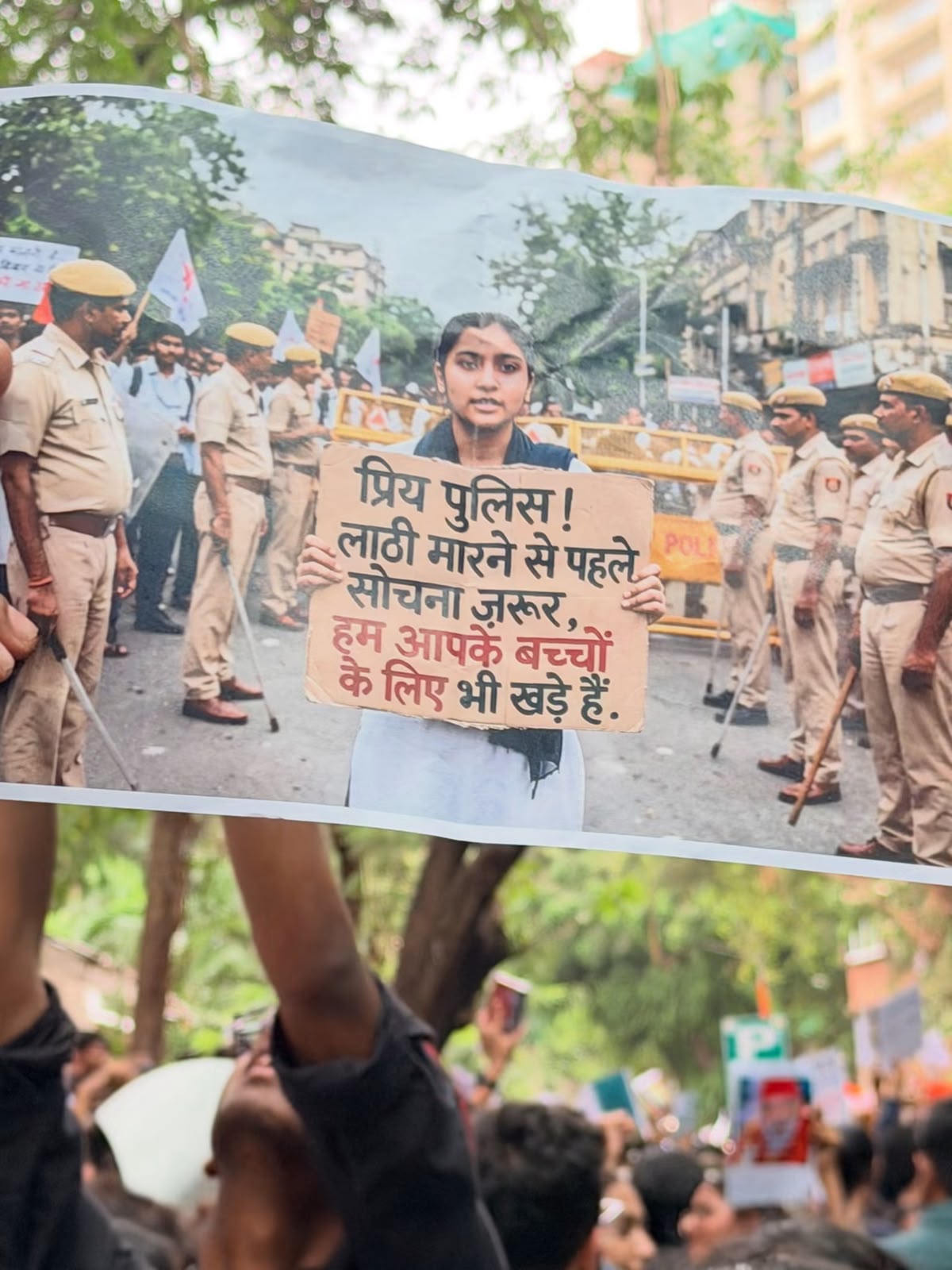 Archive photograph of a hand-made poster in a crowd