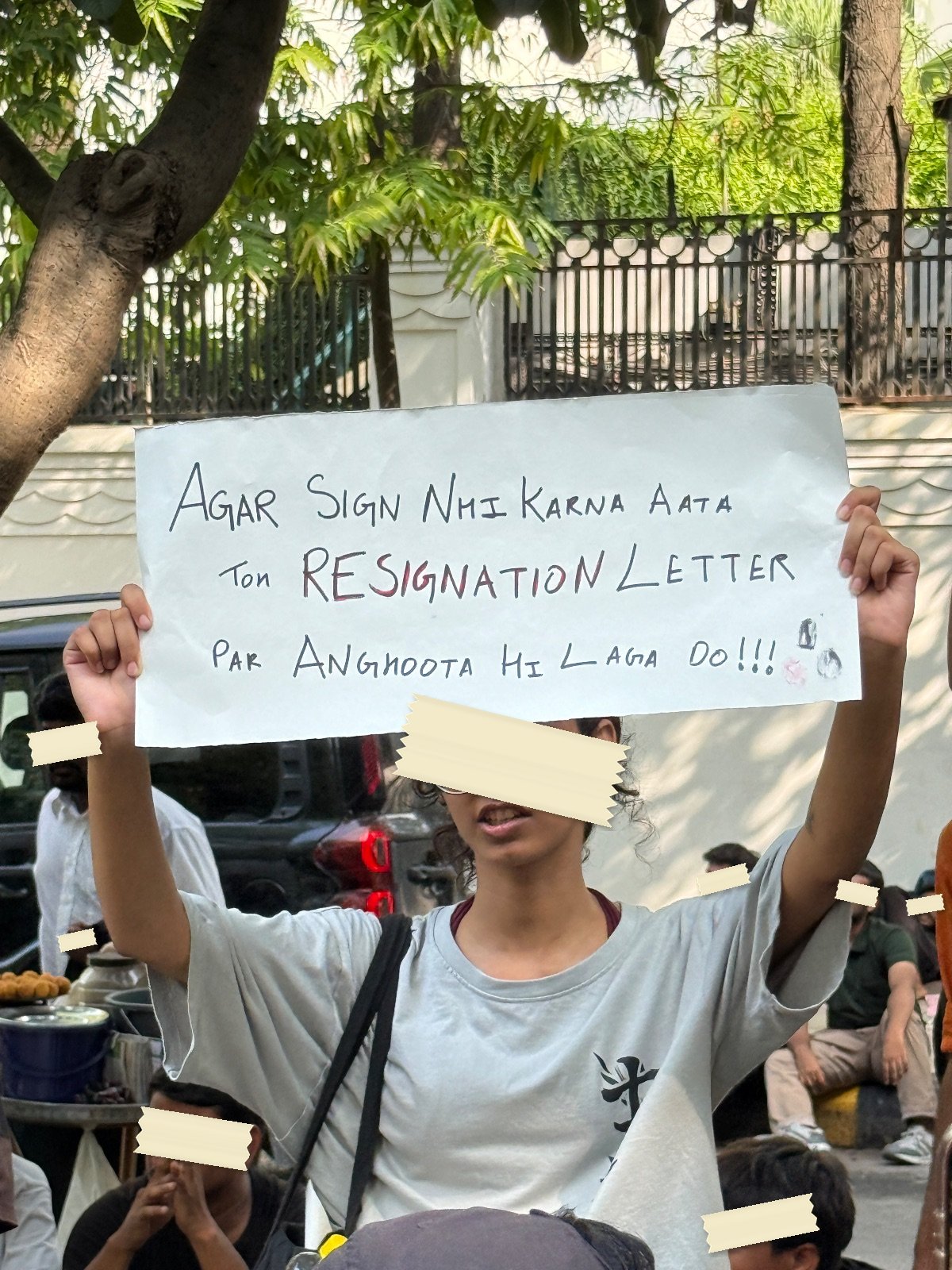A hand-lettered placard suggesting that a thumbprint would do on the resignation letter
