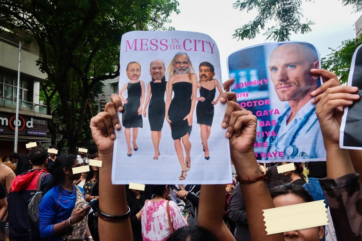 A printed sheet parodying the Sex and the City title card, reading MESS IN THE CITY above four figures in black dresses with politicians' faces pasted on
