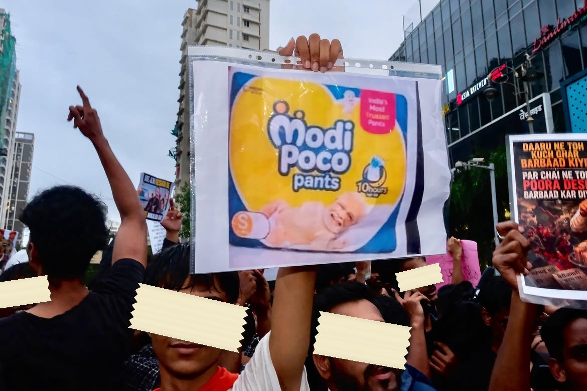 A printed parody of a nappy packet held up in a plastic sleeve at a night march