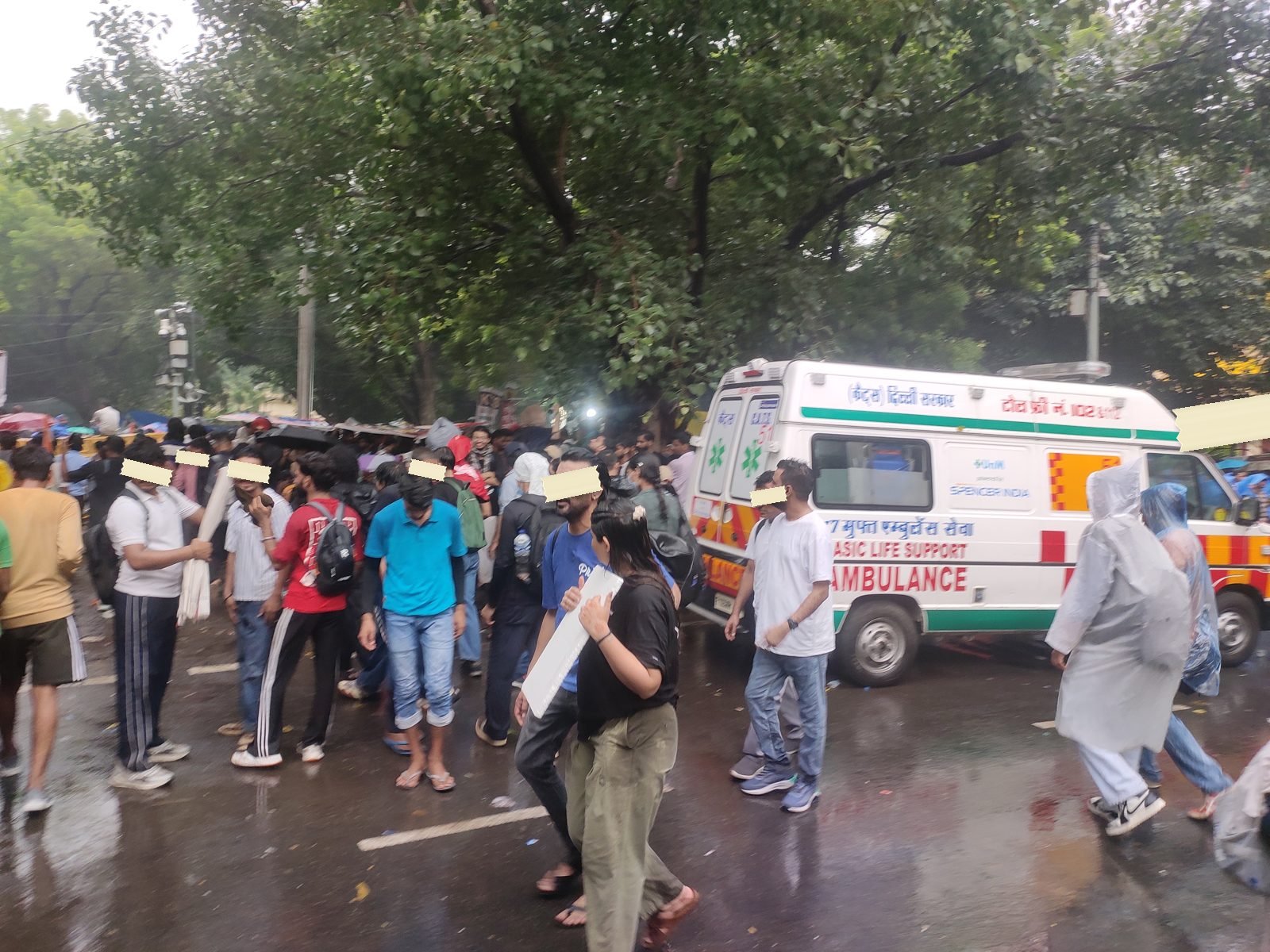 The rain-soaked crowd, with the occupied tanker and flags in the distance
