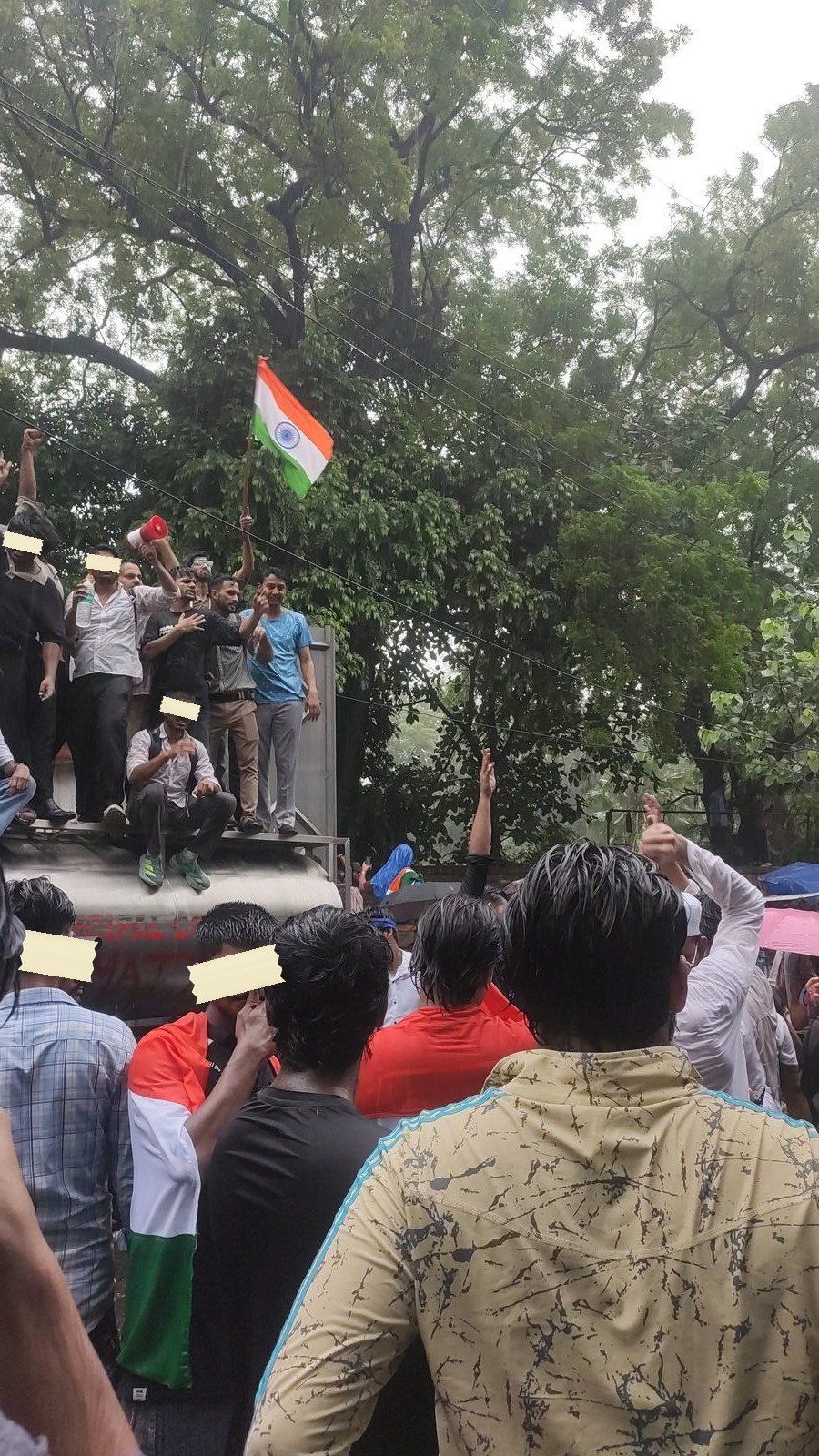 Students atop a tanker wave the tricolor at Jantar Mantar